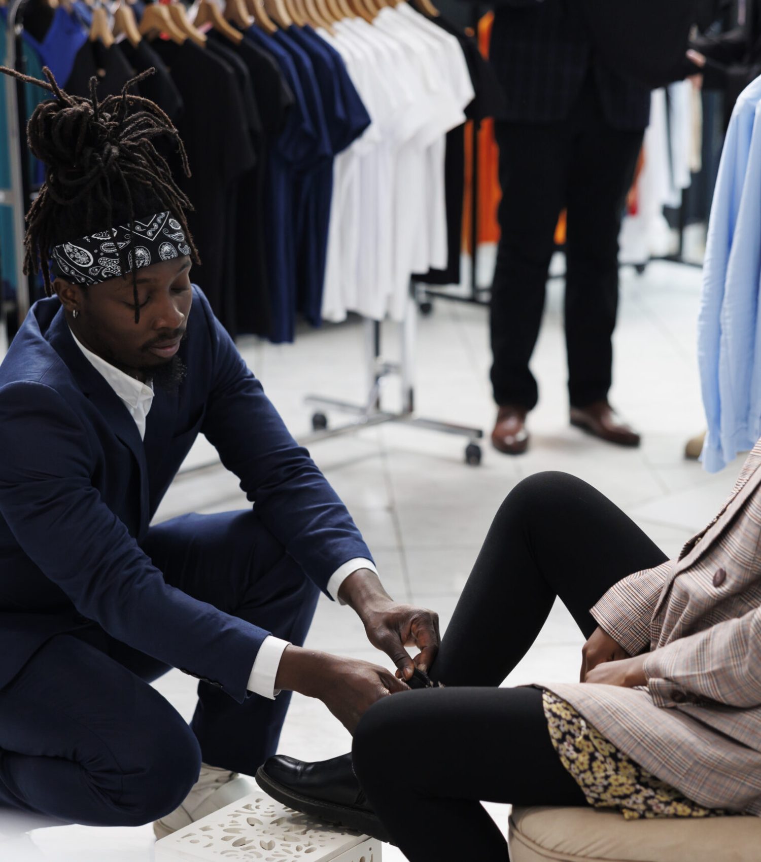 African american worker helping client with stylish shoes, woman shopping for formal wear in showroom. Fashionable customer buying fashion collection in boutique shop. Fashion concept
